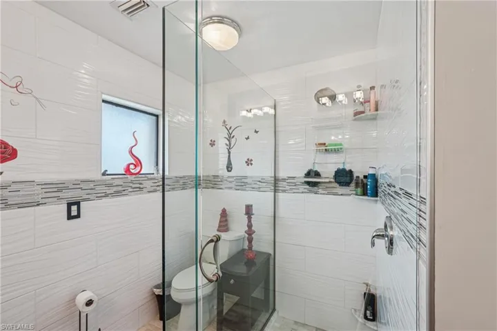 Bathroom with a stall shower and toilet