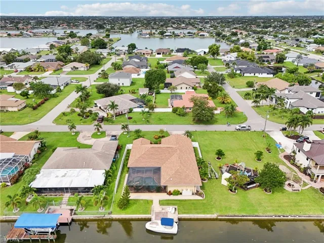 Aerial view of residential area featuring a nearby body of water