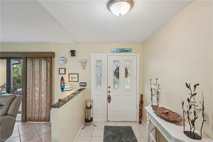 Entryway with light tile patterned floors