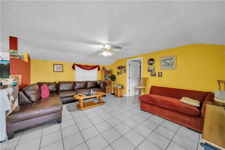 Guest house Living area featuring ceiling fan and light tile patterned flooring