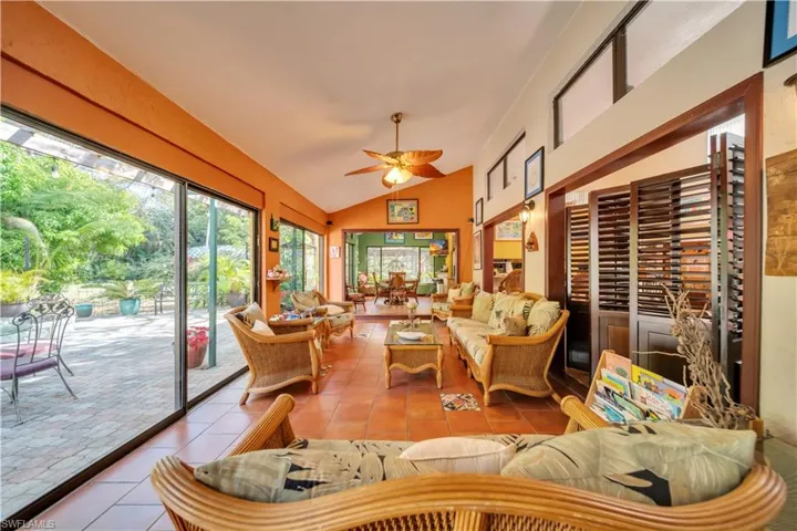Sunroom / solarium featuring vaulted ceiling and tile patterned floors