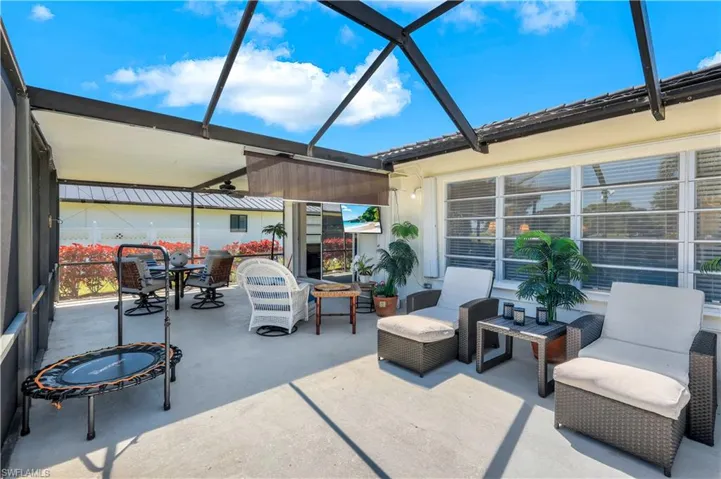Screened lanai with under cover dining and open sun lounging area.