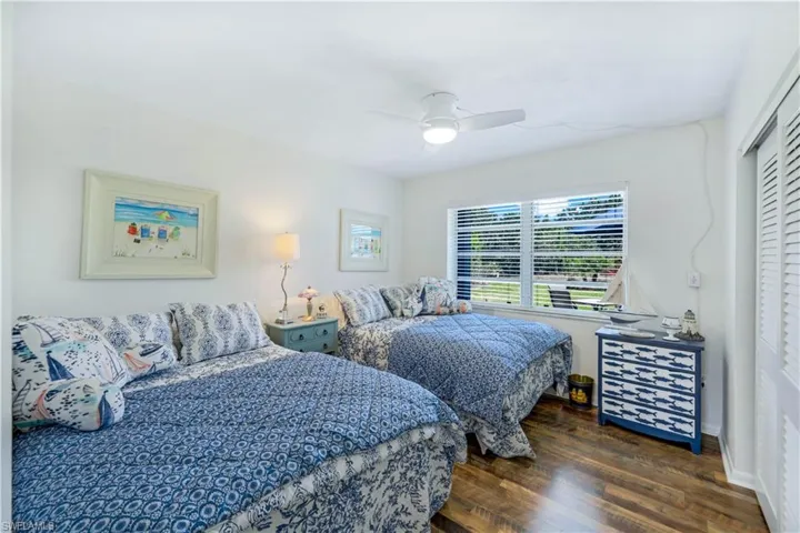 Second bedroom with double beds and storage.