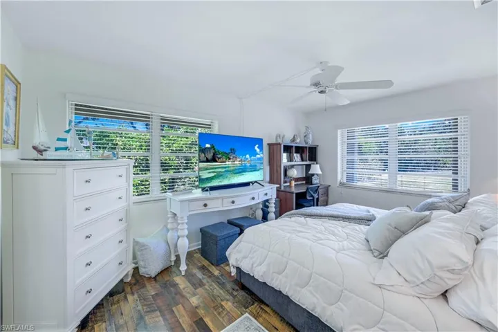 Bedroom with dark wood-type flooring and ceiling fan