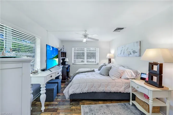Bright Master Bedroom with desk and TV