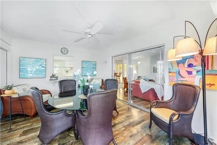 Dining area with wood finished floors and a ceiling fan.  Great space as an office/den also.