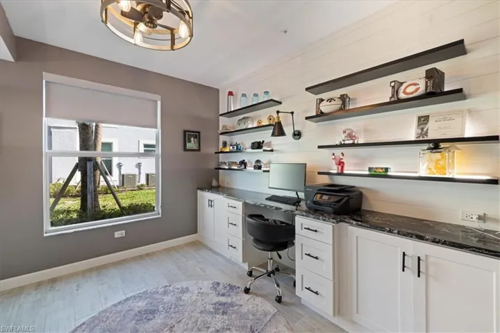 Office space with light tile floors and built in study area