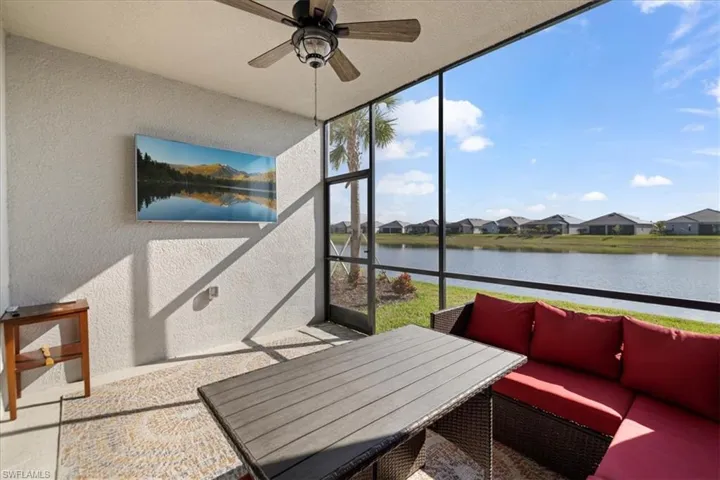 Rear lanai, with a ceiling fan, a patio, an outdoor hangout area, and a water view.