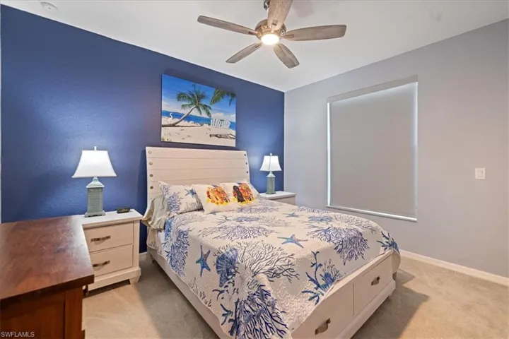 Bedroom with light colored carpet and ceiling fan