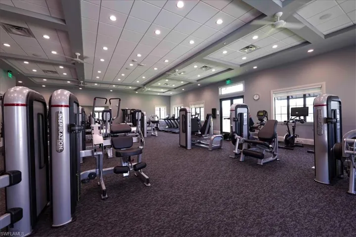 Exercise room with dark colored carpet and recessed lighting