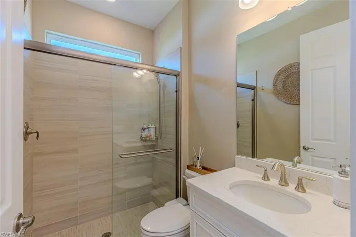 Full bath featuring vanity and a shower stall