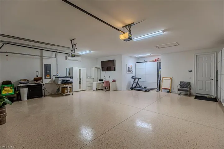 Garage with electric panel and a garage door opener