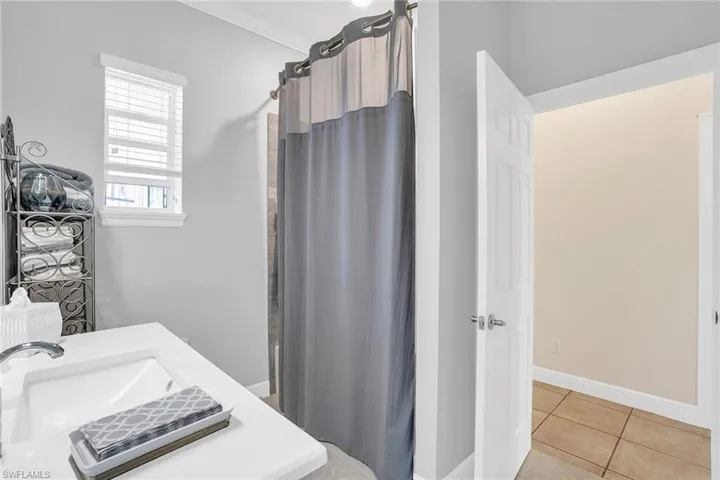 With tub/shower and door to pool area