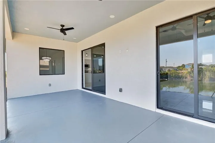 View of patio / terrace with 2 ceiling fans and canal view