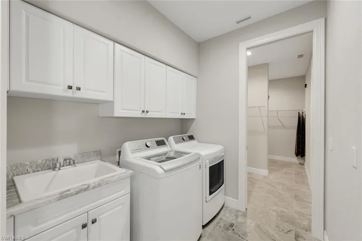 Laundry Room with Access to Primary Bedroom Walk-in Closets