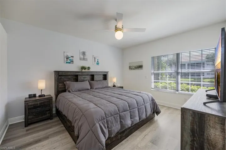 Bedroom with ceiling fan and hardwood / wood-style flooring