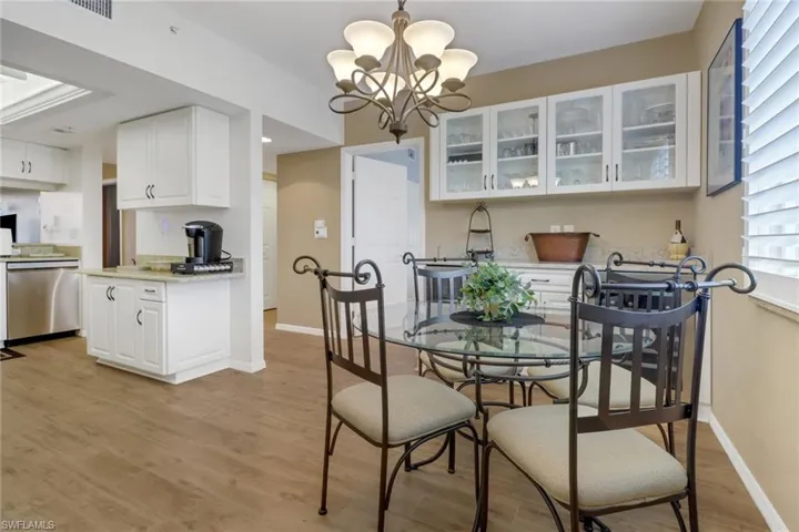 Dining space with a notable chandelier and light wood-type flooring