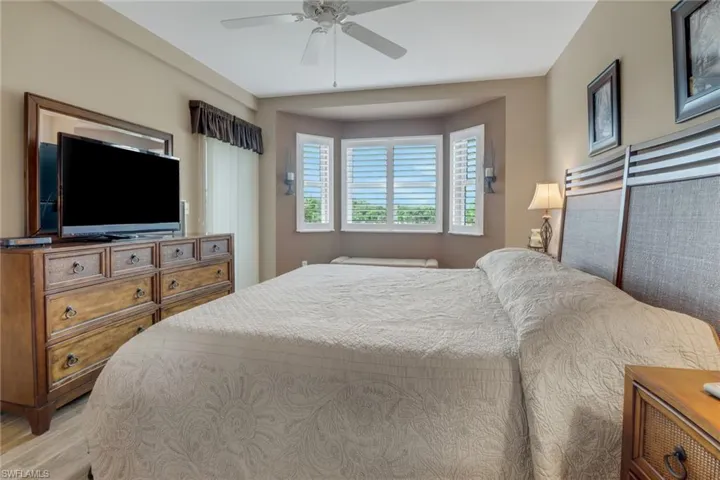 Bedroom with light hardwood / wood-style floors and ceiling fan