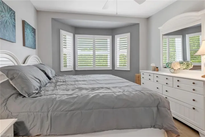 Bedroom with hardwood / wood-style floors and ceiling fan