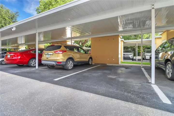 View of parking featuring a carport