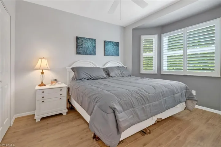 Bedroom with ceiling fan and light wood-type flooring