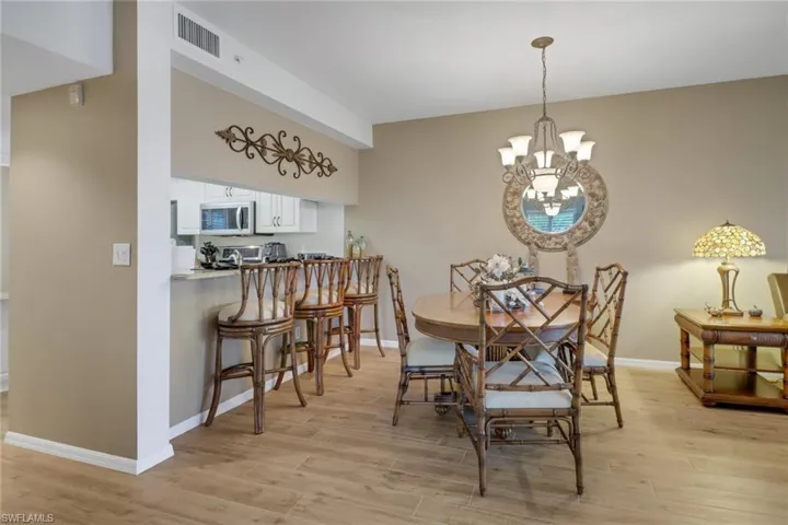 Dining space featuring light hardwood / wood-style floors and an inviting chandelier