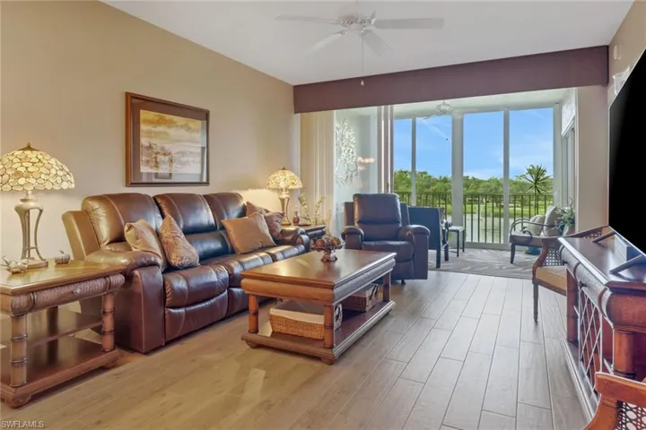 Living room with light wood-type flooring and ceiling fan