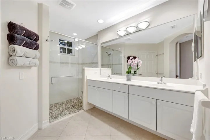 NATURAL LIGHT AND SPACIOUS CONVENIENCE.  UPDATED SHOWER AND HIS AND HERS AREAS!