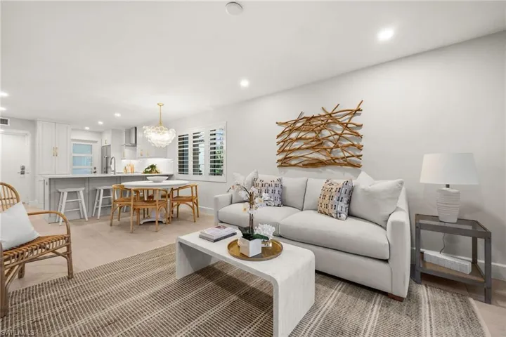 Bright and inviting open-concept living with stylish board and batten accents and coastal-inspired design.