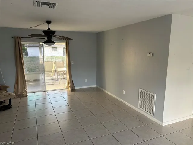 Unfurnished room with light tile patterned floors and a ceiling fan