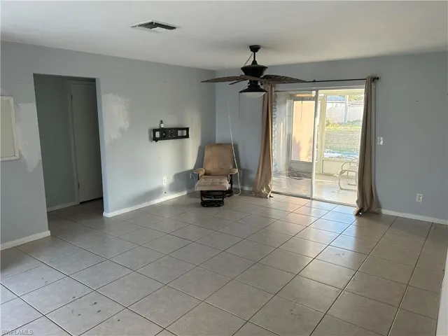 Unfurnished room with a ceiling fan and light tile patterned floors