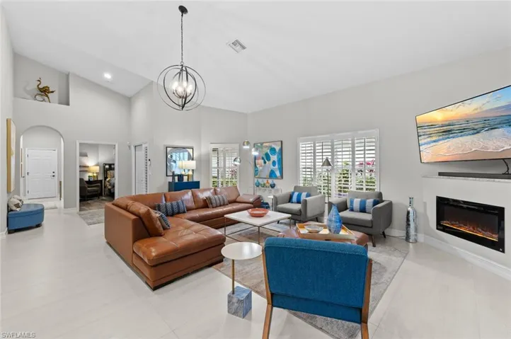 Living room with an inviting chandelier and high vaulted ceiling