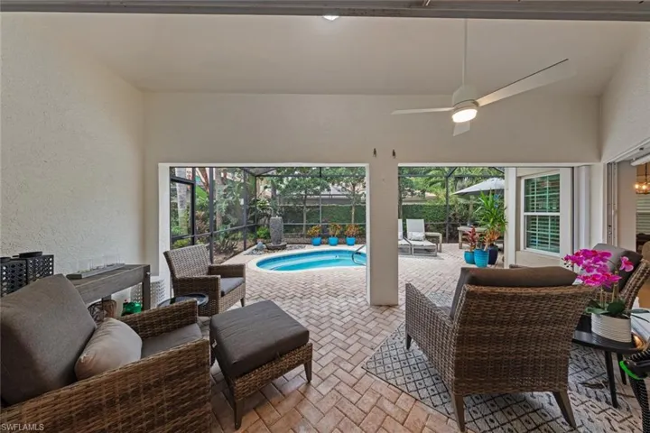 View of patio / terrace with a lanai, ceiling fan, an outdoor hangout area, and a fenced in pool