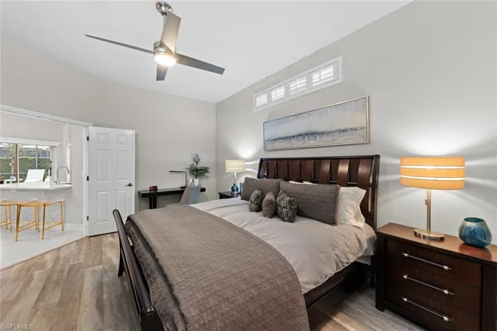 Bedroom with ceiling fan, light wood-type flooring, and sink