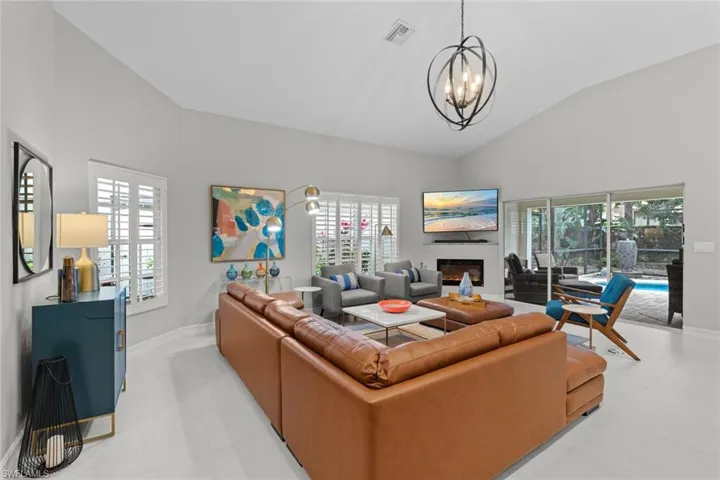 Living room featuring a chandelier and vaulted ceiling