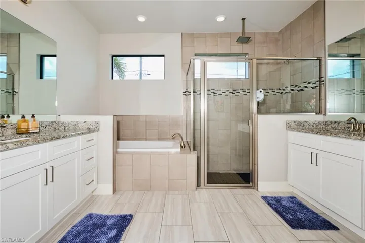 Primary Bathroom with independent shower and bath and dual vanities