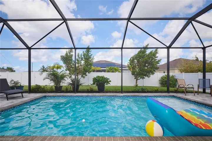 View of swimming pool with a patio and a lanai