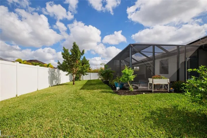View of yard featuring vinyl fencing