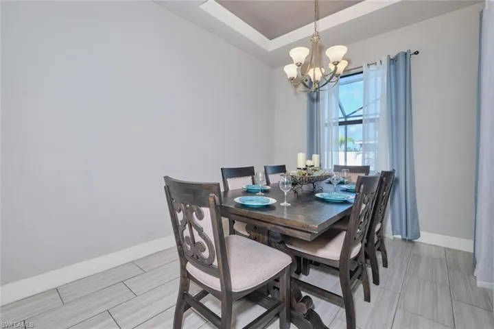 Dining space featuring a chandelier and a tray ceiling