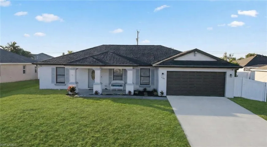 Single story home featuring stucco siding, concrete driveway, covered porch, and an attached garage