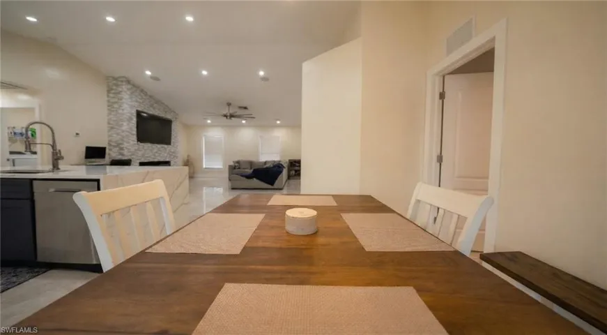 Dining room featuring lofted ceiling, ceiling fan, and recessed lighting