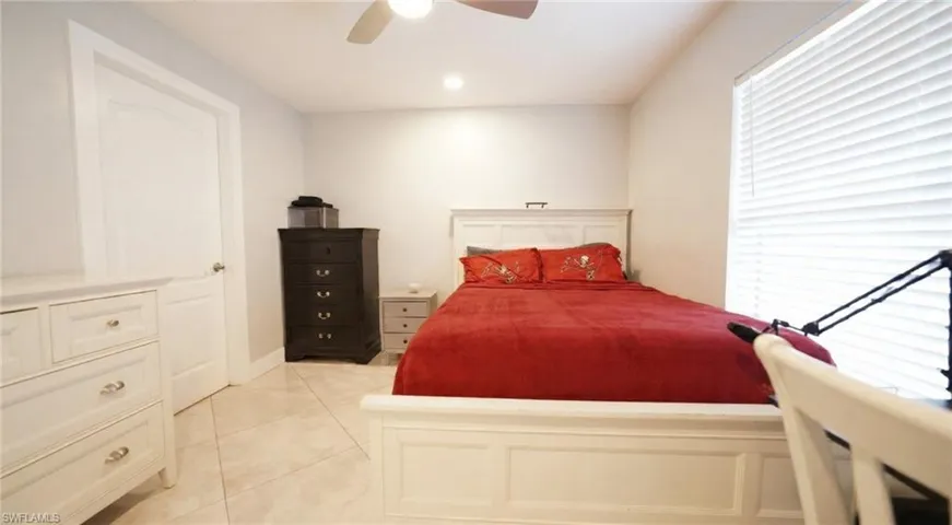 Bedroom with light tile patterned flooring, a ceiling fan, and recessed lighting