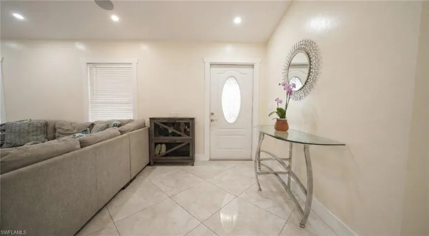 Foyer entrance with recessed lighting and light tile patterned floors