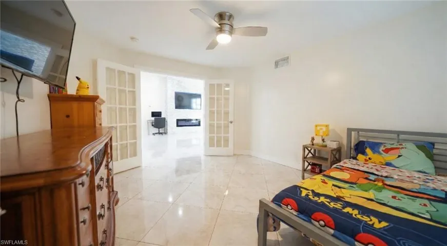 Bedroom featuring french doors and ceiling fan