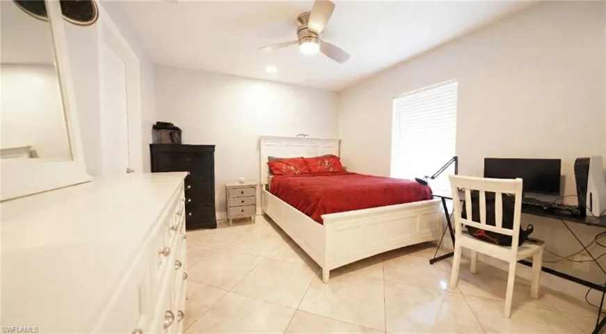 Bedroom featuring light tile patterned floors, a ceiling fan, and recessed lighting