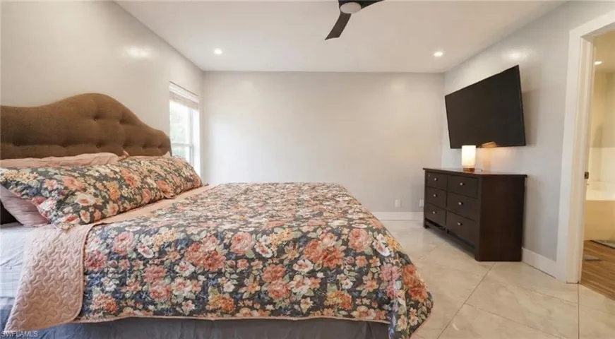 Bedroom featuring a ceiling fan, recessed lighting, and light tile patterned floors