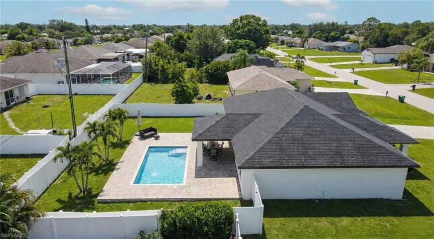 Aerial view of residential area featuring a pool area