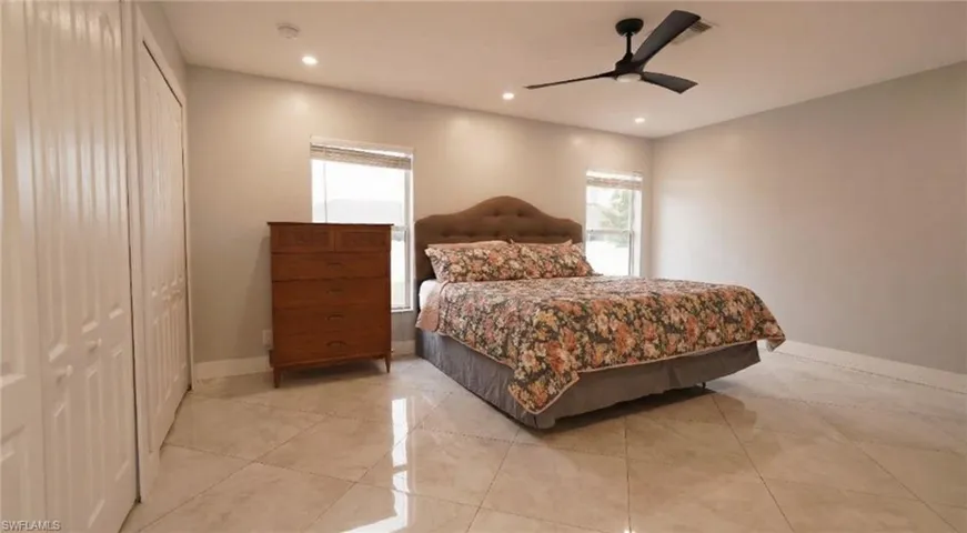 Bedroom featuring ceiling fan, recessed lighting, and a closet