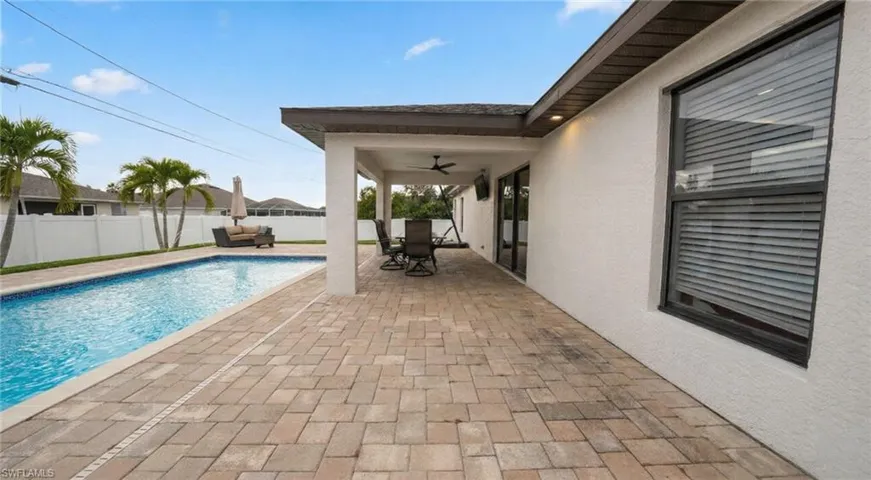 View of swimming pool with a fenced backyard, outdoor dining area, and a patio area