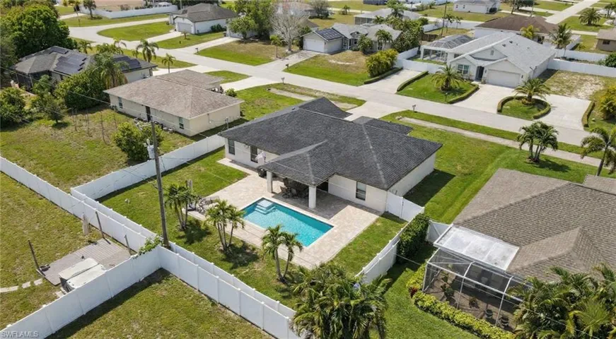 Aerial perspective of suburban area featuring a pool area